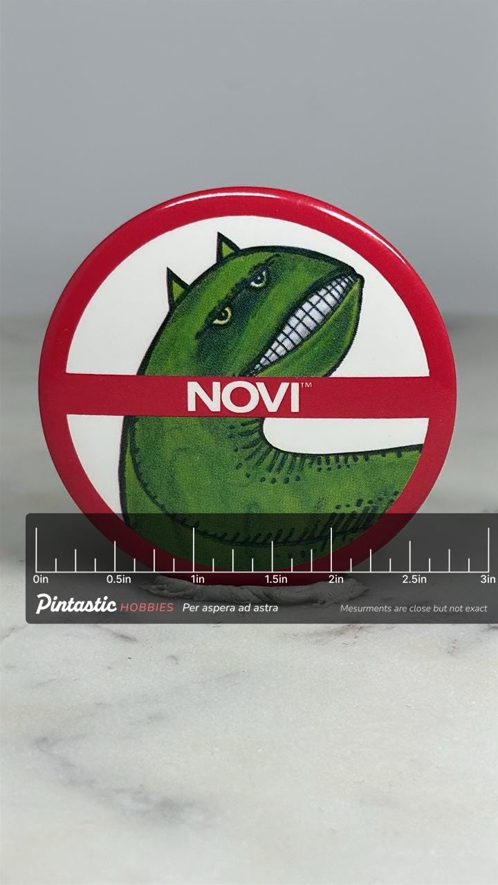 Novi Dinosaur Parody Pin: Red/White Finish - Retro Humor Accessory with ruler overlay for size reference