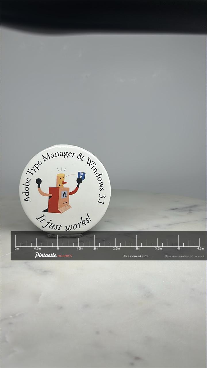 Adobe Type Manager Button Pin: Retro Graphic - 90s Tech Accessory with ruler overlay for size reference