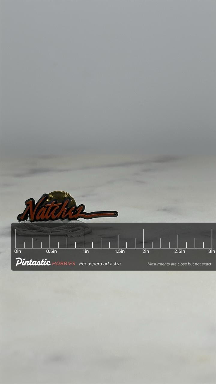 Natchez Souvenir Pin: Red Script with Sunset - Vintage Travel Accessory with ruler overlay for size reference