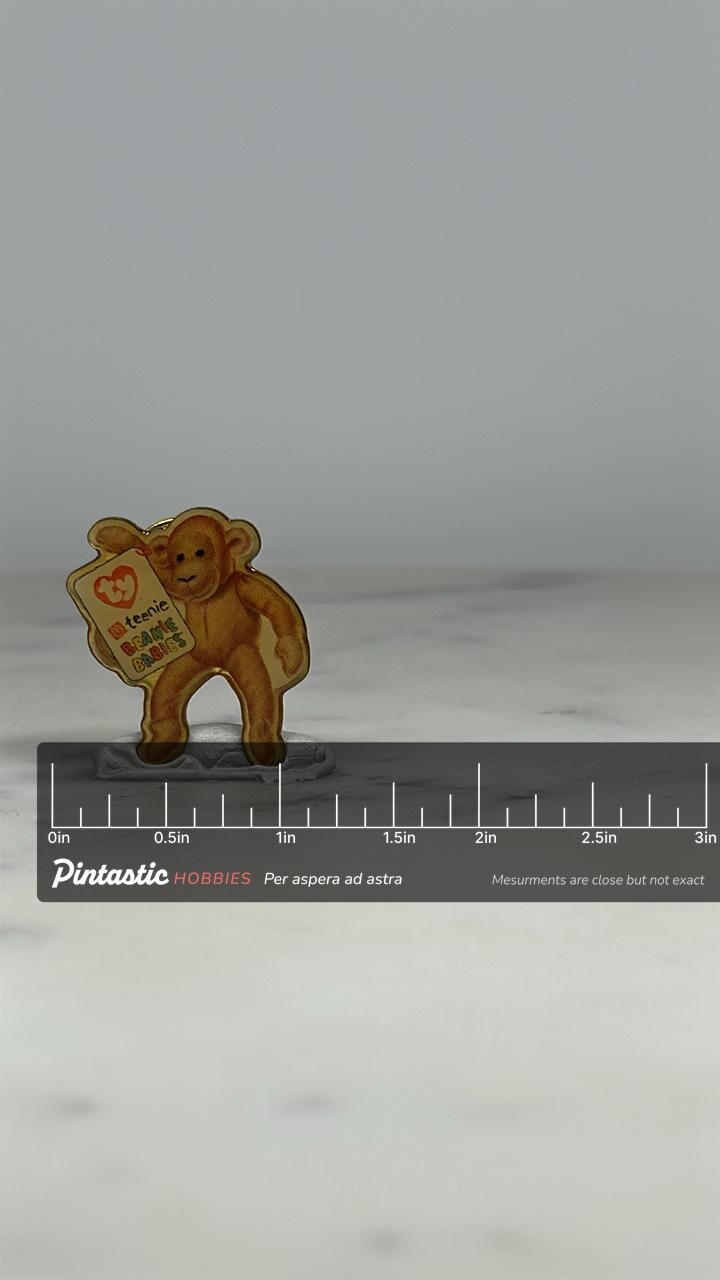 Beanie Babies Monkey Pin: Glossy Light Brown Finish - 90s Toy Collectible with ruler overlay for size reference