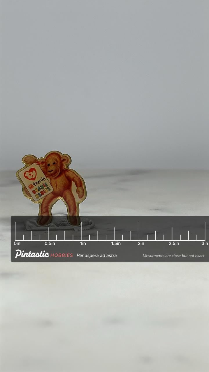 Beanie Babies Monkey Pin: Glossy Brown Finish - 90s Toy Collectible Accessory with ruler overlay for size reference