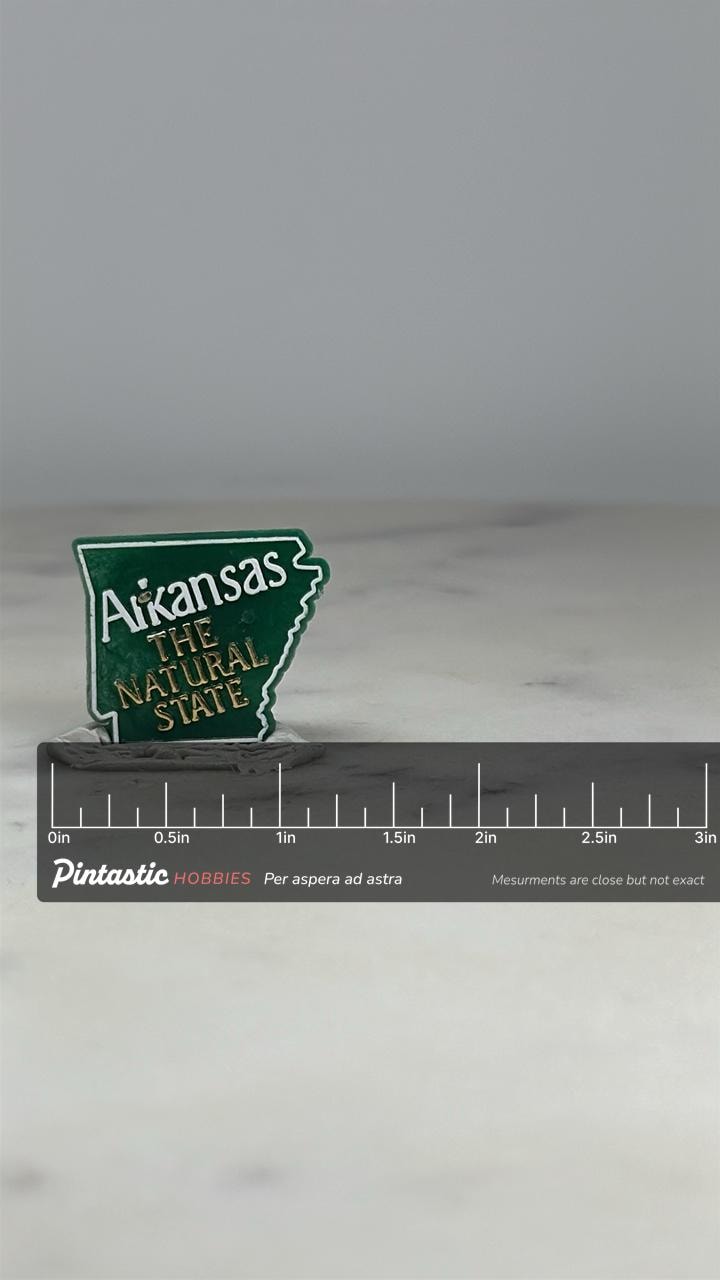 Arkansas State Souvenir Pin: Green Enamel Outline - Vintage Travel Accessory with ruler overlay for size reference