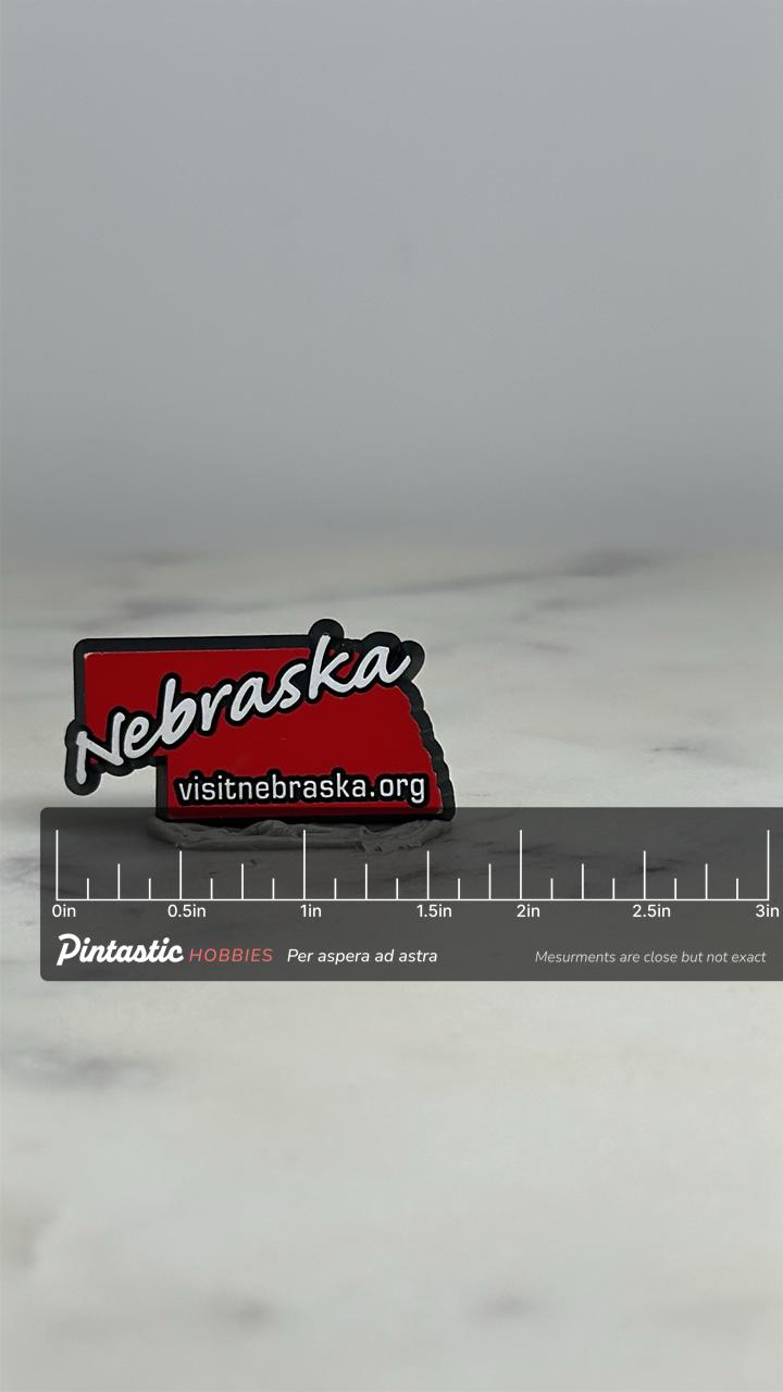 Nebraska State Souvenir Pin: Red Enamel - Travel Tourism Accessory with ruler overlay for size reference