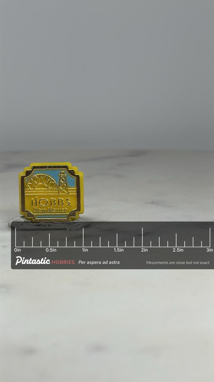 Hobbs New Mexico Souvenir Pin: Yellow Enamel - Travel Landmark Accessory with ruler overlay for size reference