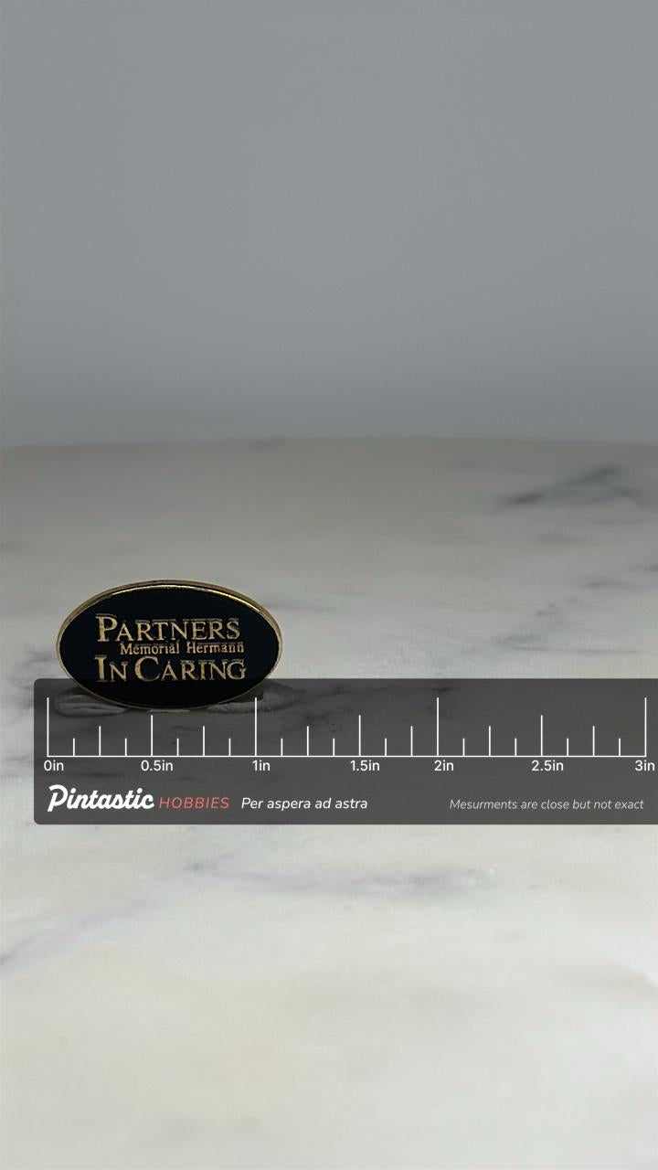 Memorial Hermann Partners in Caring Pin: Black Gold Oval - Healthcare Tribute Accessory with ruler overlay for size reference