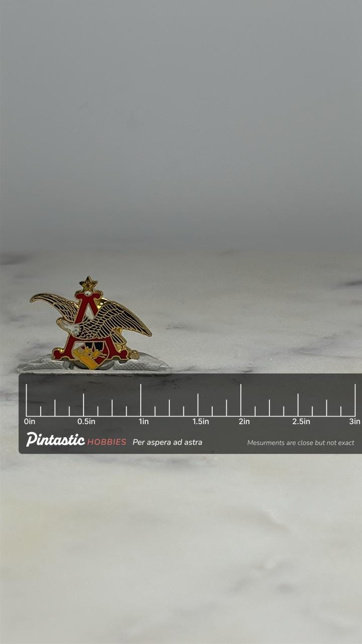 Anheuser-Busch Eagle Pin: Gold Red Enamel - Vintage Beer Accessory with ruler overlay for size reference