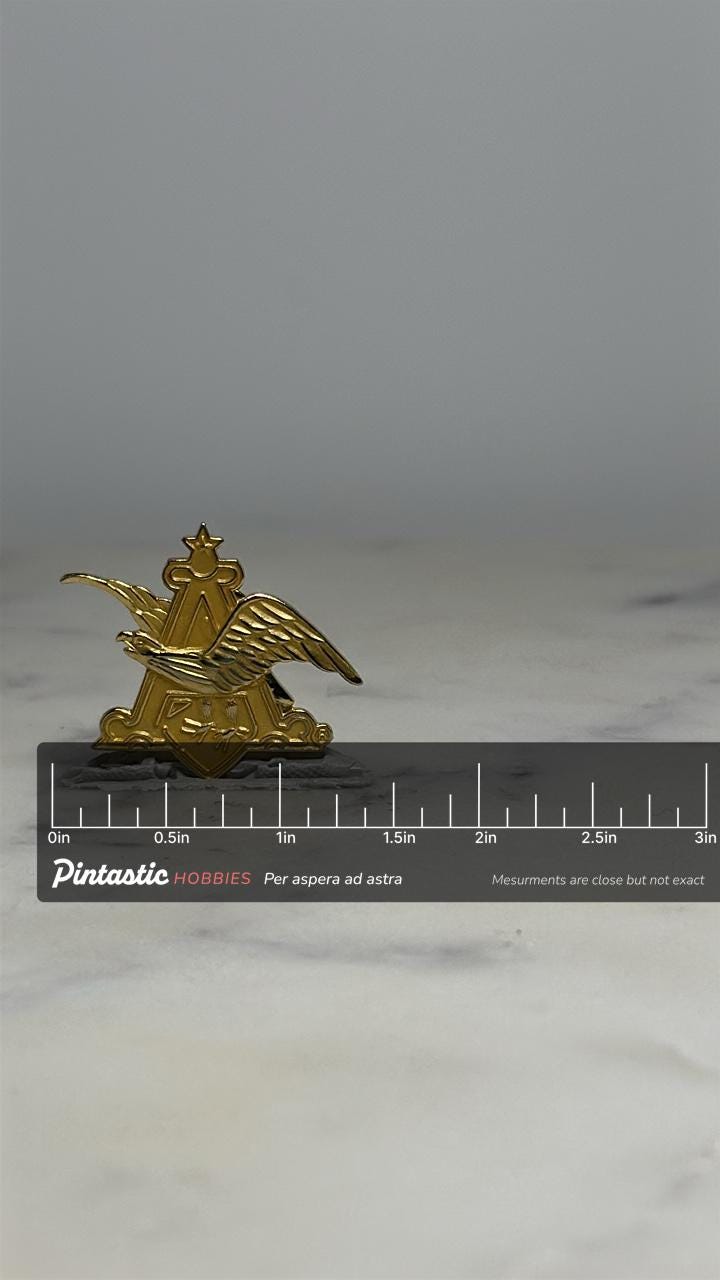 Anheuser-Busch Eagle Pin: Gold Tone Metal - Vintage Patriotic Accessory with ruler overlay for size reference