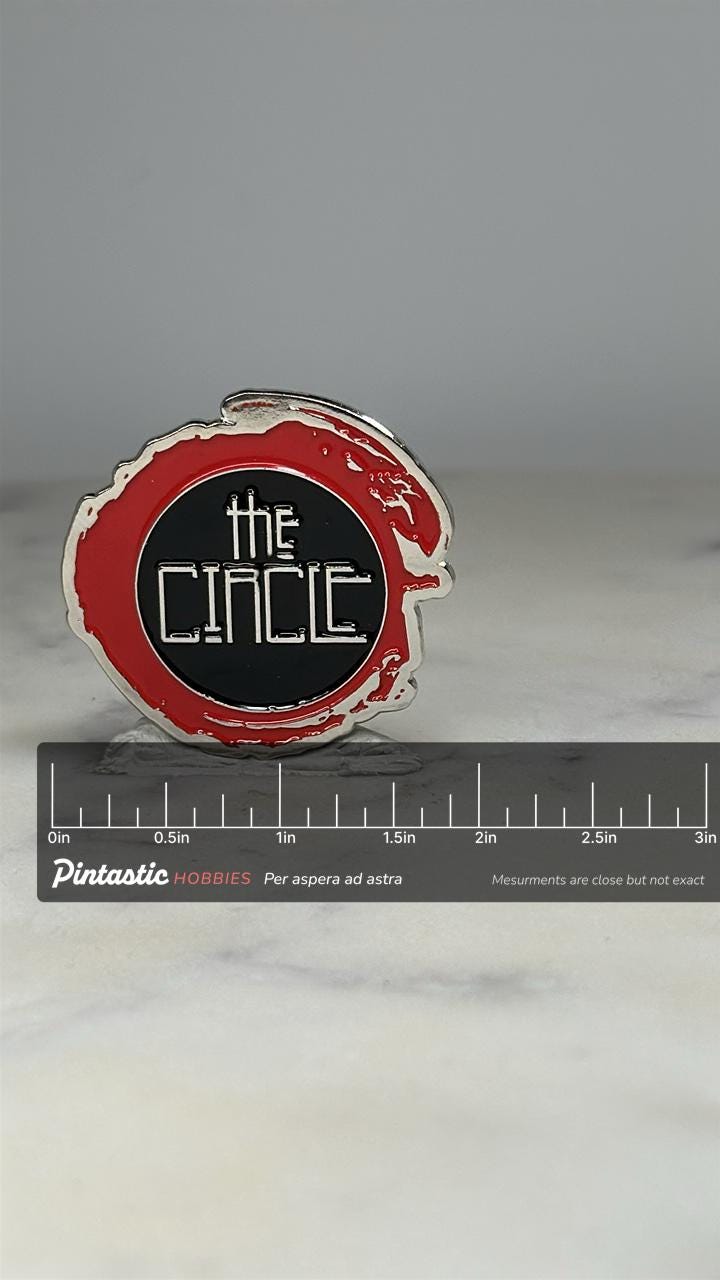 The Circle Rock Band Enamel Pin: Red & Black Metal - Pop Culture Accessory with ruler overlay for size reference