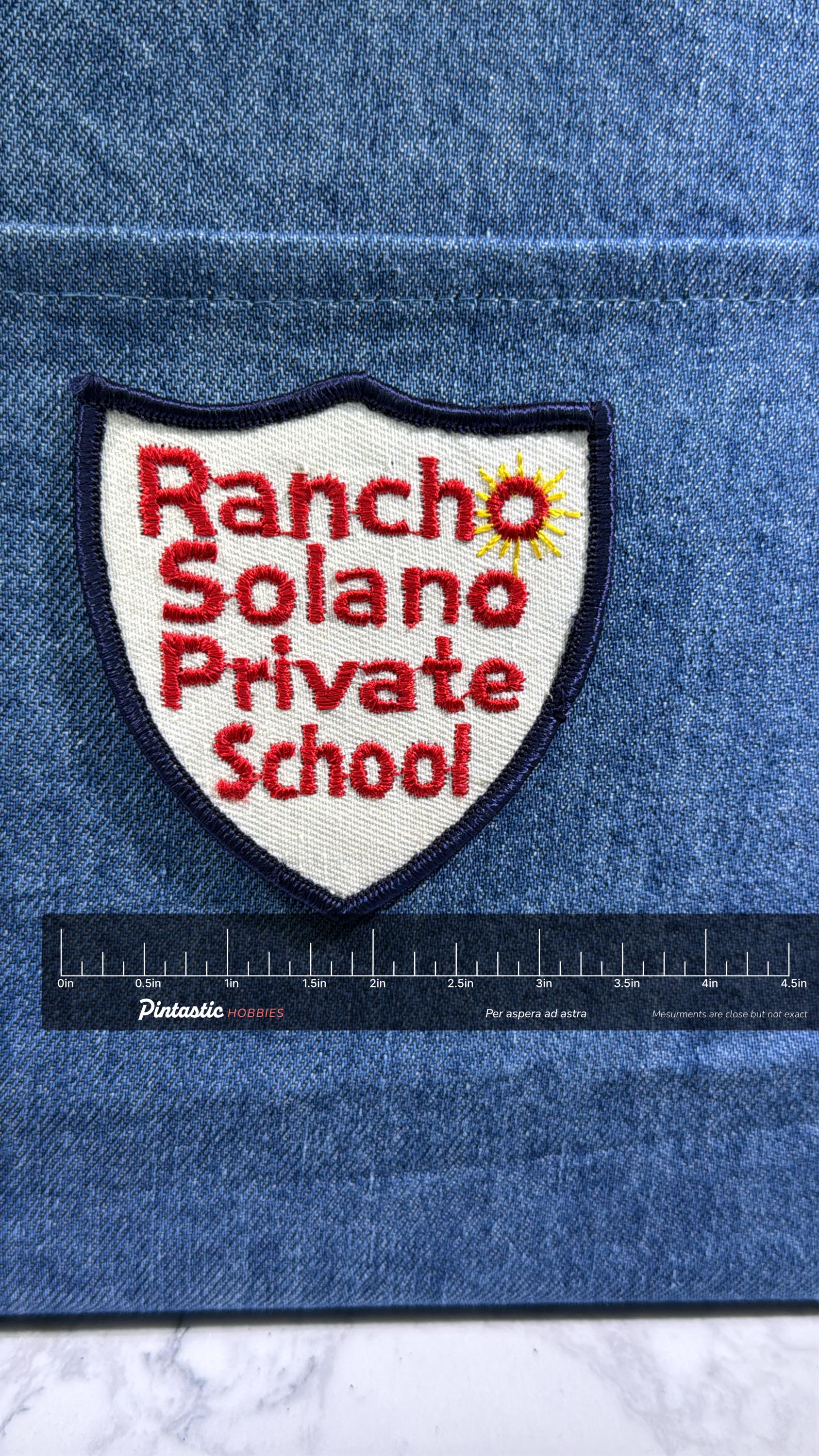 Rancho Solano School Collectable Patch: Iron-On Shield White/Red - Academic Accessory with ruler overlay for size reference