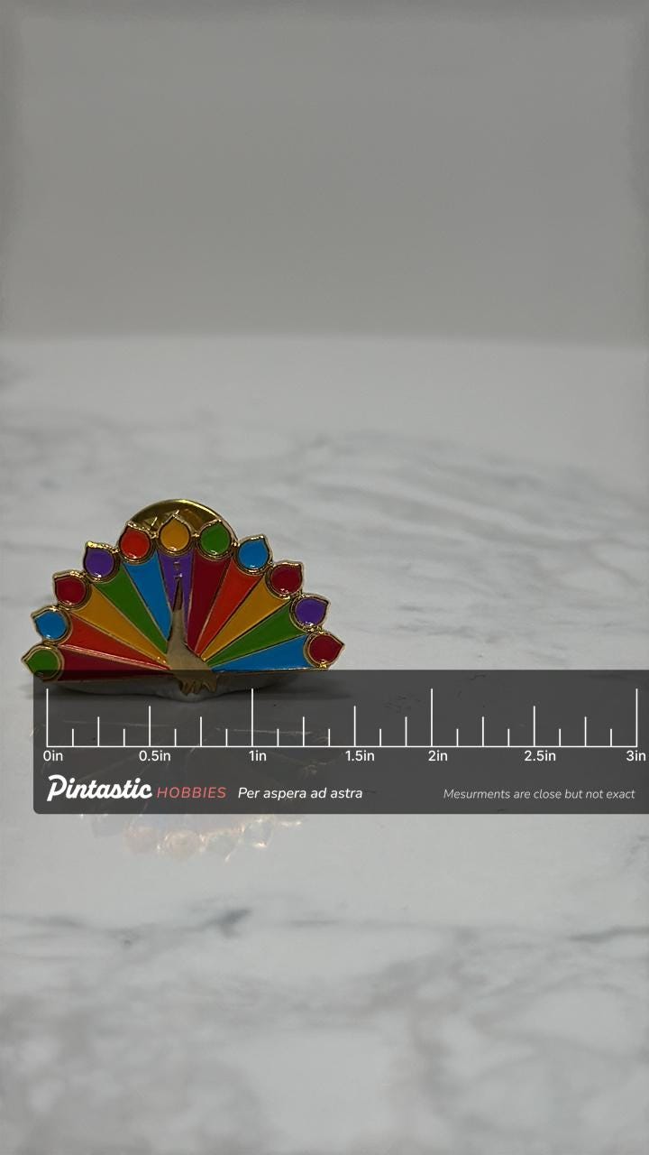 NBC Peacock Enamel Pin: Rainbow Colors - Retro TV Accessory with ruler overlay for size reference