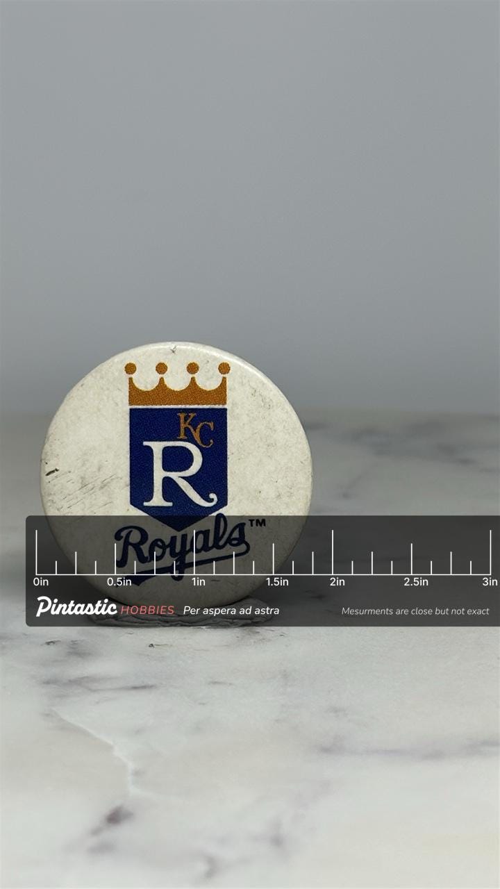 Kansas City Royals Button Pin: White & Blue - Vintage Sports Accessory with ruler overlay for size reference