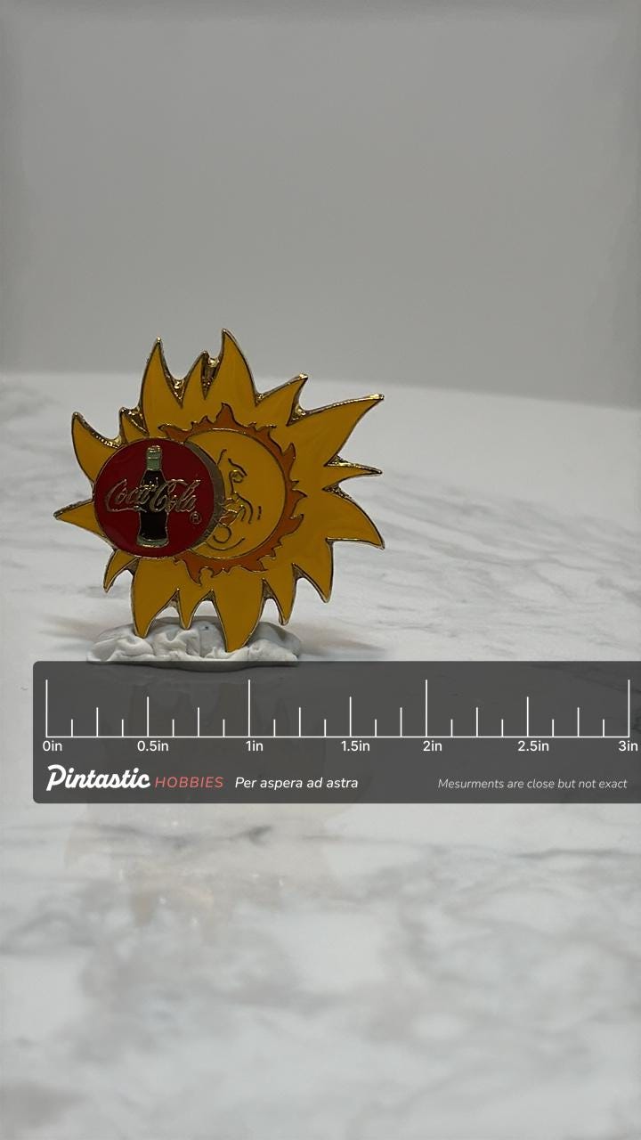 Coca-Cola Sun Logo Pin: Red & Gold Enamel - Retro Soda Accessory with ruler overlay for size reference