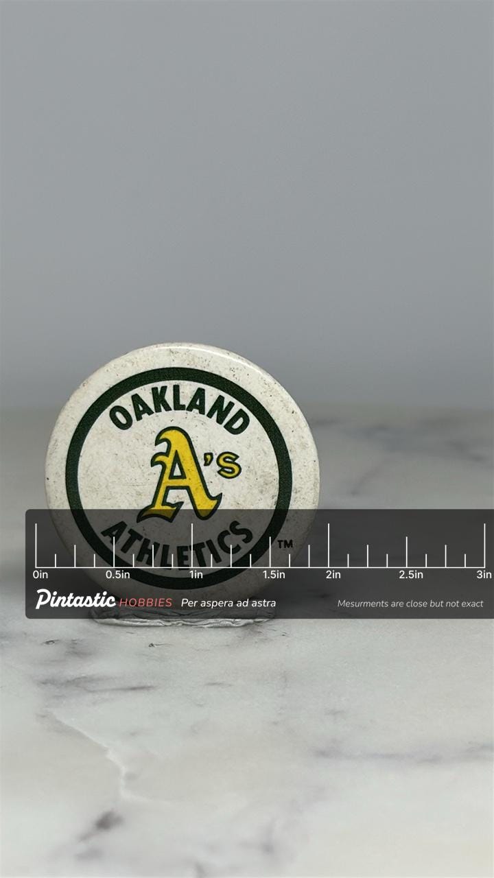 Oakland Athletics Button Pin: Green & Yellow Logo - Vintage Sports Accessory with ruler overlay for size reference