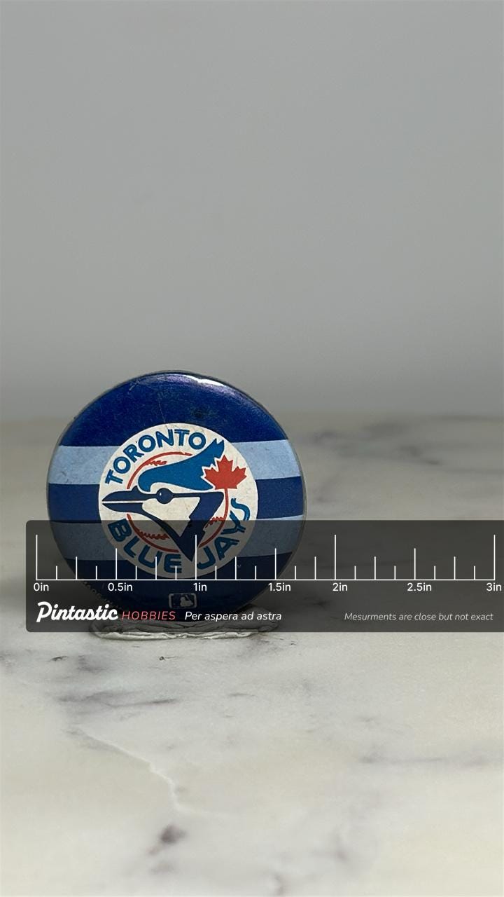 Toronto Blue Jays Button Pin: Blue & White Stripes - Vintage Sports Accessory with ruler overlay for size reference