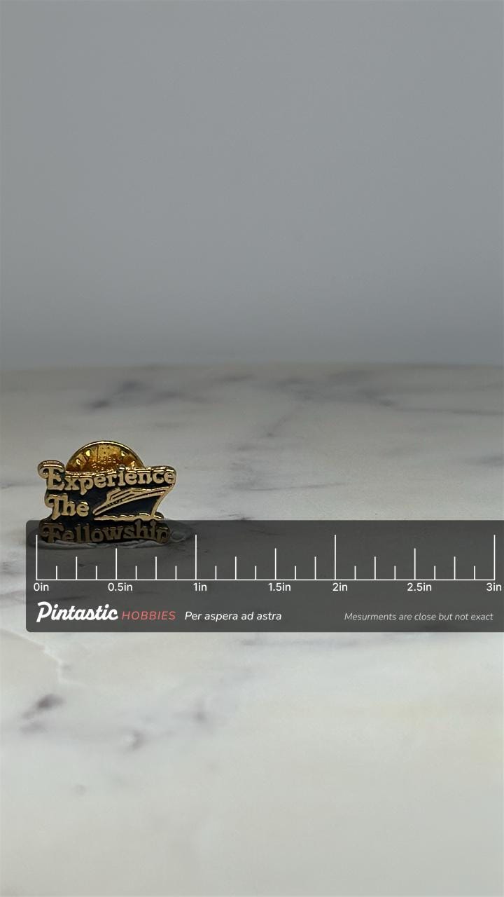 Experience The Fellowship Pin: Gold Black Enamel - Faith-Based Accessory with ruler overlay for size reference