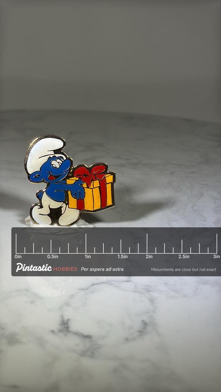Smurfs Gift Enamel Pin: Bright Colors - 80s Cartoon Accessory with ruler overlay for size reference