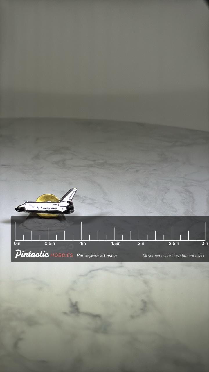Space Shuttle Enamel Pin: White & Black Finish - NASA Era Accessory with ruler overlay for size reference