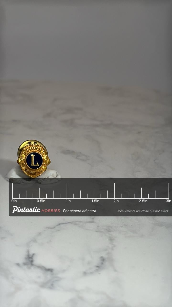 Lions Club International Pin: Gold & Black Enamel Finish - Vintage Organization Accessory with ruler overlay for size referen
