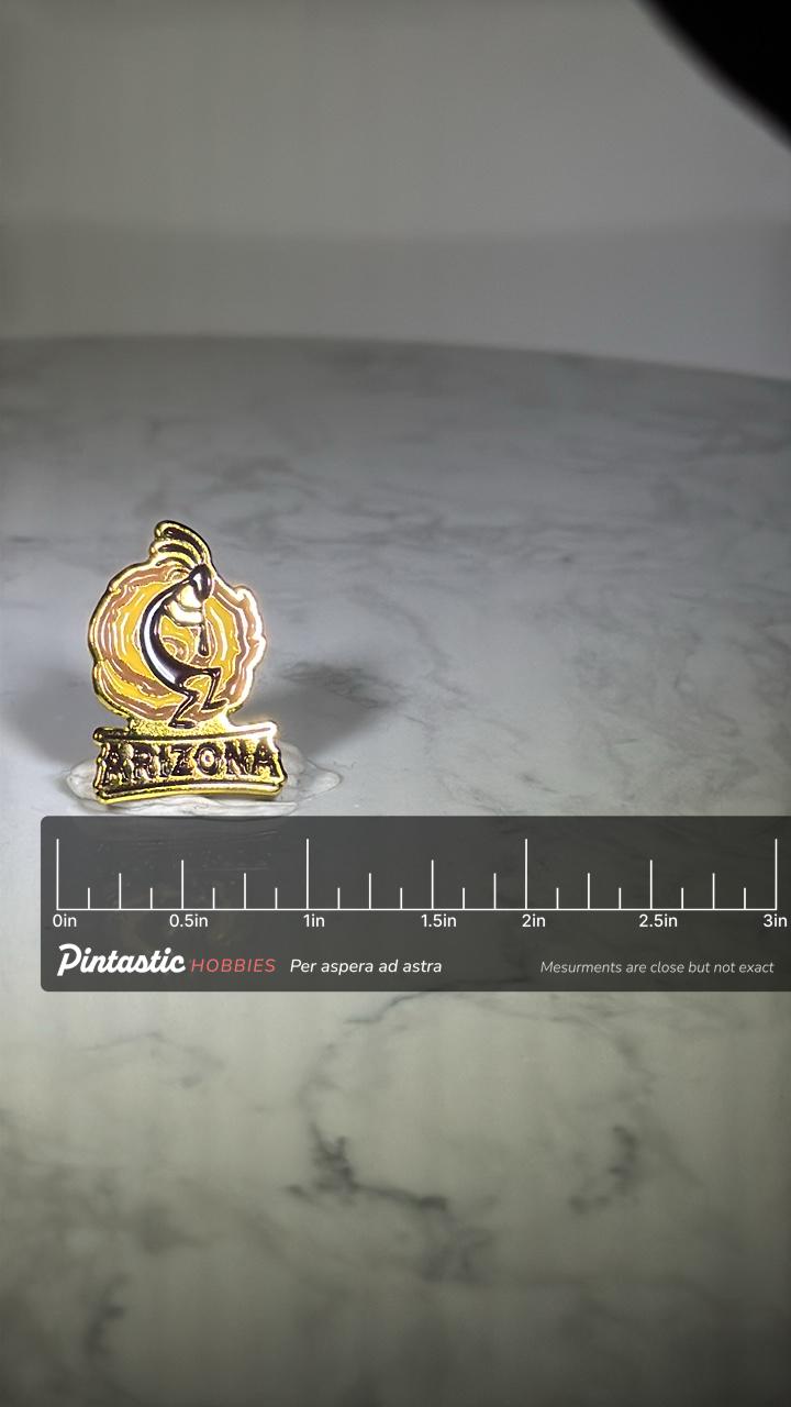 Arizona Kokopelli Pin: Gold Enamel Finish - Southwest Souvenir Accessory with ruler overlay for size reference