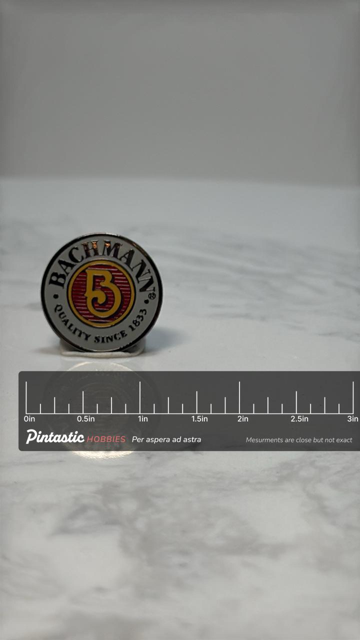 Bachmann Model Railroad 5 Year Enamel Pin: Red & Gold Logo - Vintage Career Accessory with ruler overlay for size reference