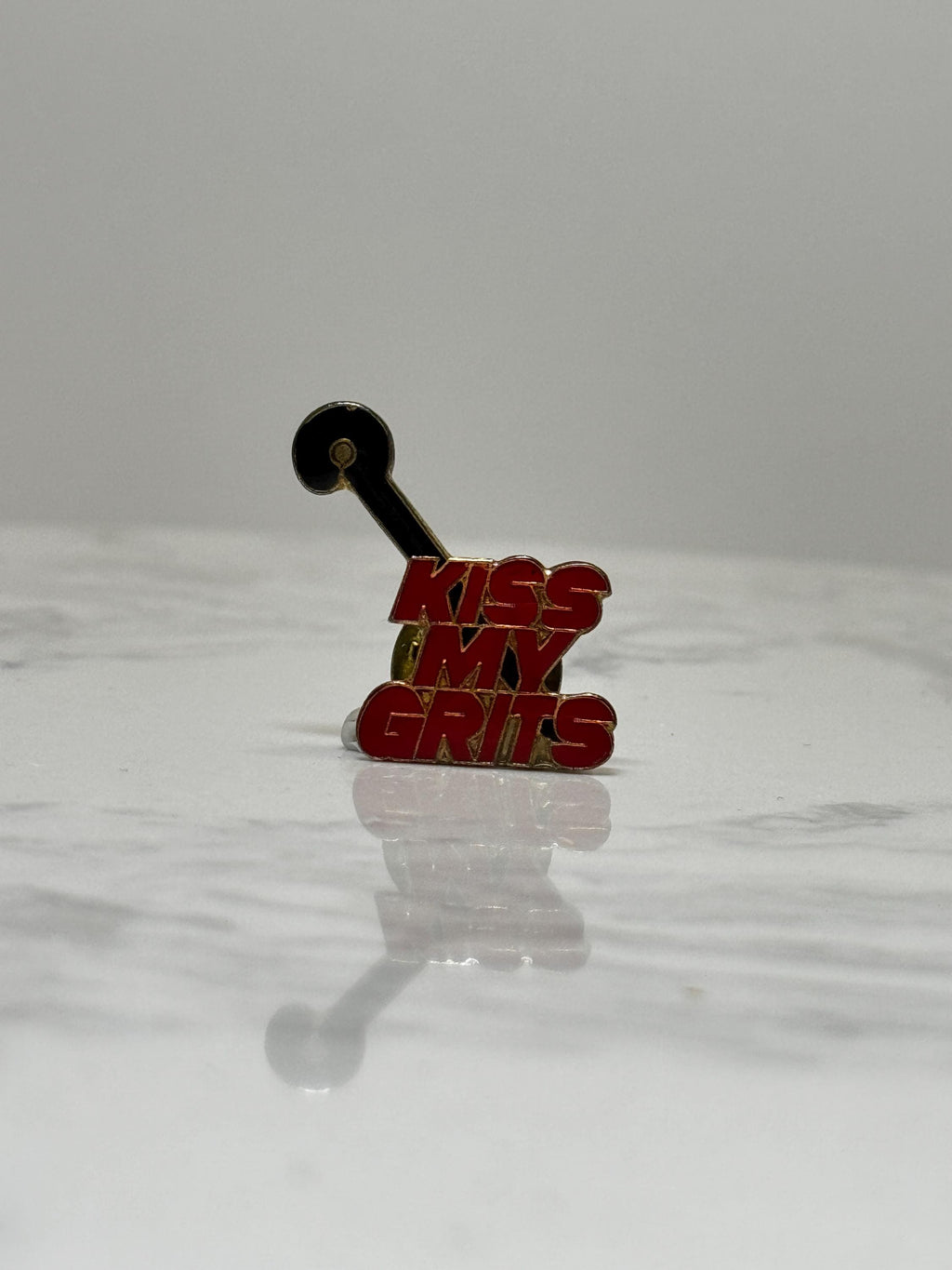 Kiss My Grits Enamel Pin: Red Gold Retro - 1980s TV Accessory