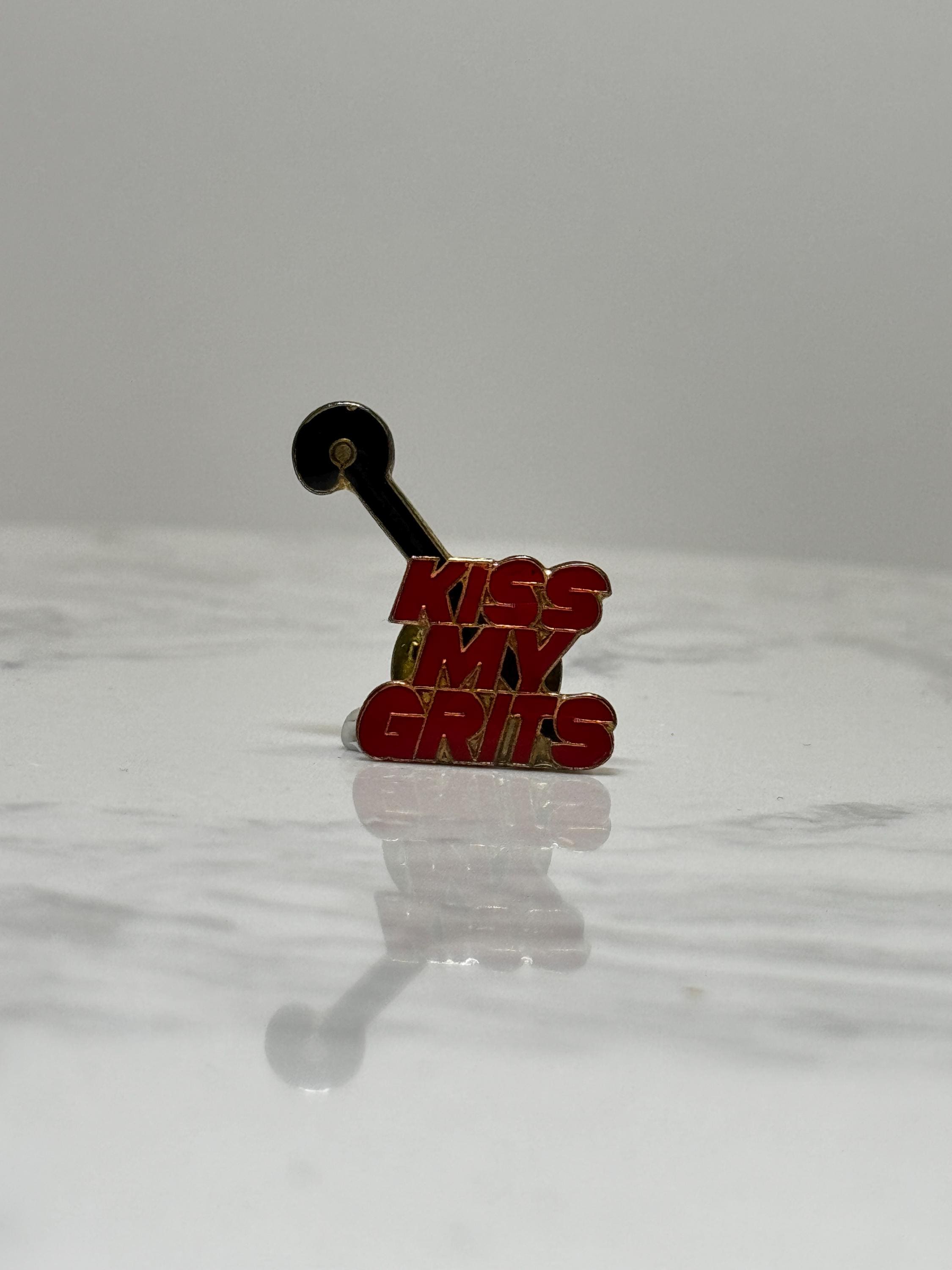 Kiss My Grits Enamel Pin: Red Gold Retro - 1980s TV Accessory