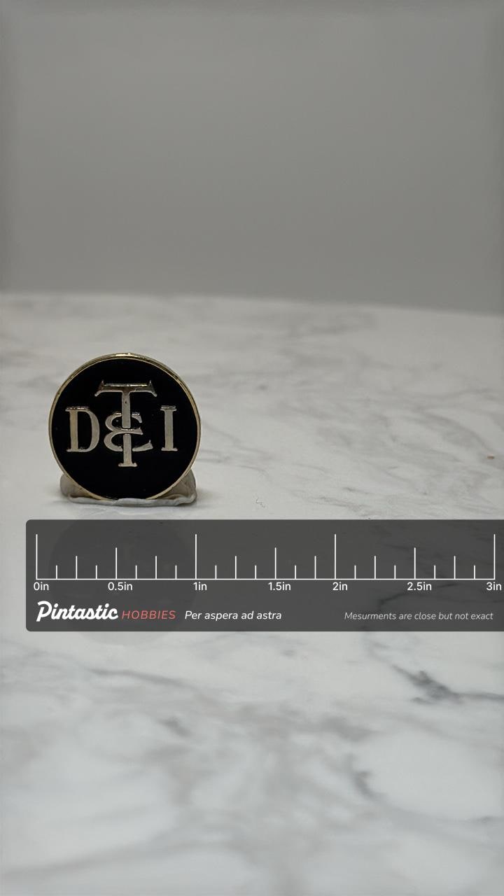 Vintage D&TI Railroad Pin: Detroit Toledo Ironton Train Logo Lapel Badge with ruler overlay for size reference