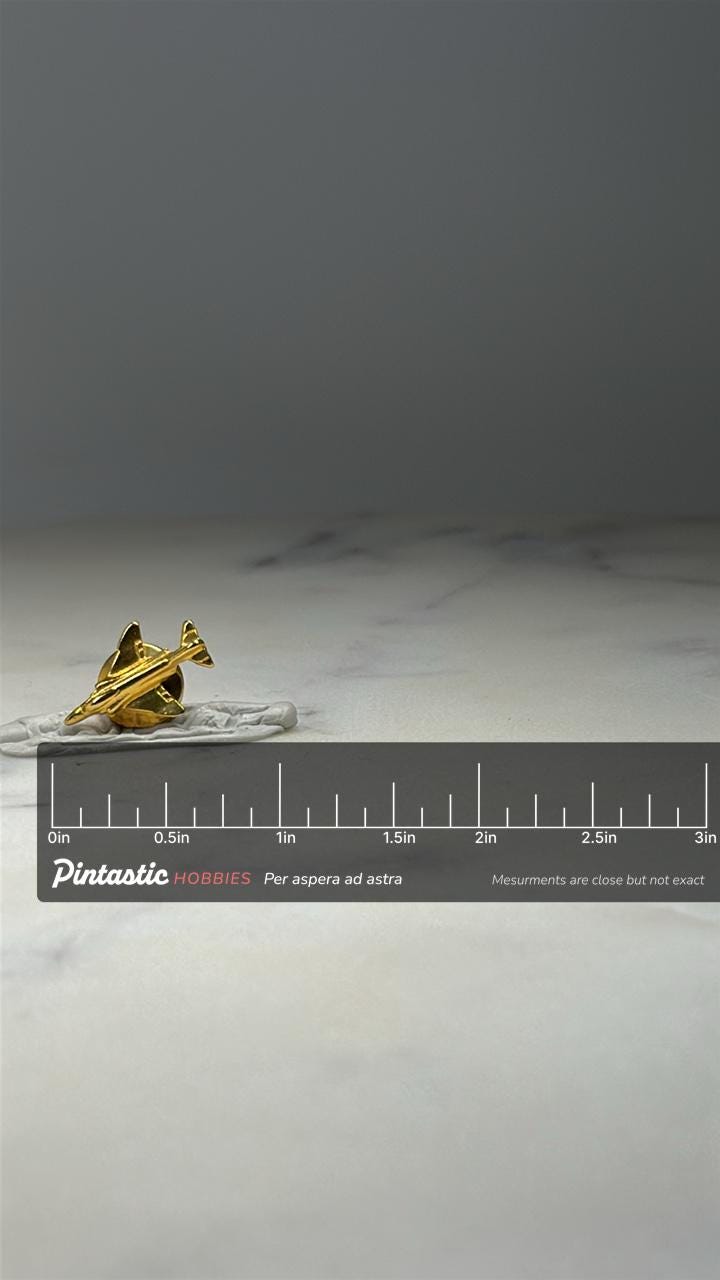 F 16 Fighting Falcon Jet Pin Gold Tone Military Aircraft Lapel Pin with ruler overlay for size reference