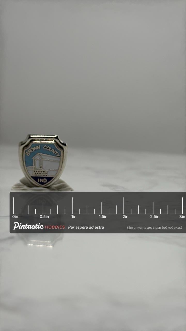 Brown County Indiana Souvenir Pin: Enamel Shield - Travel Accessory with ruler overlay for size reference