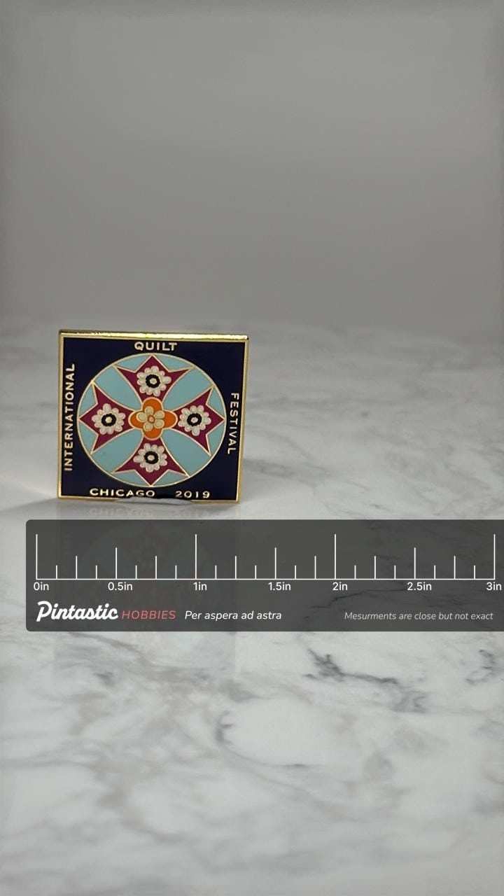 International Quilt Festival Pin: Gold Tone Enamel - Chicago 2019 with ruler overlay for size reference