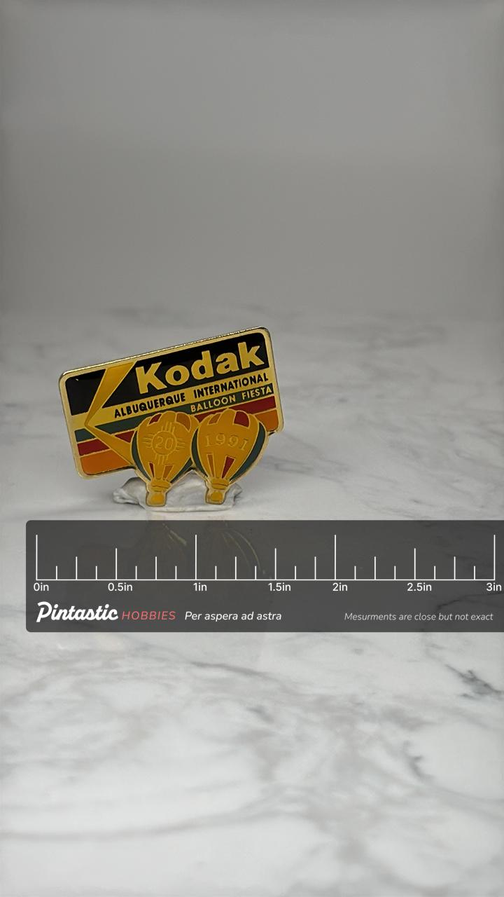 Kodak Balloon Fiesta Pin: Gold Enamel - 1991 Event Souvenir with ruler overlay for size reference