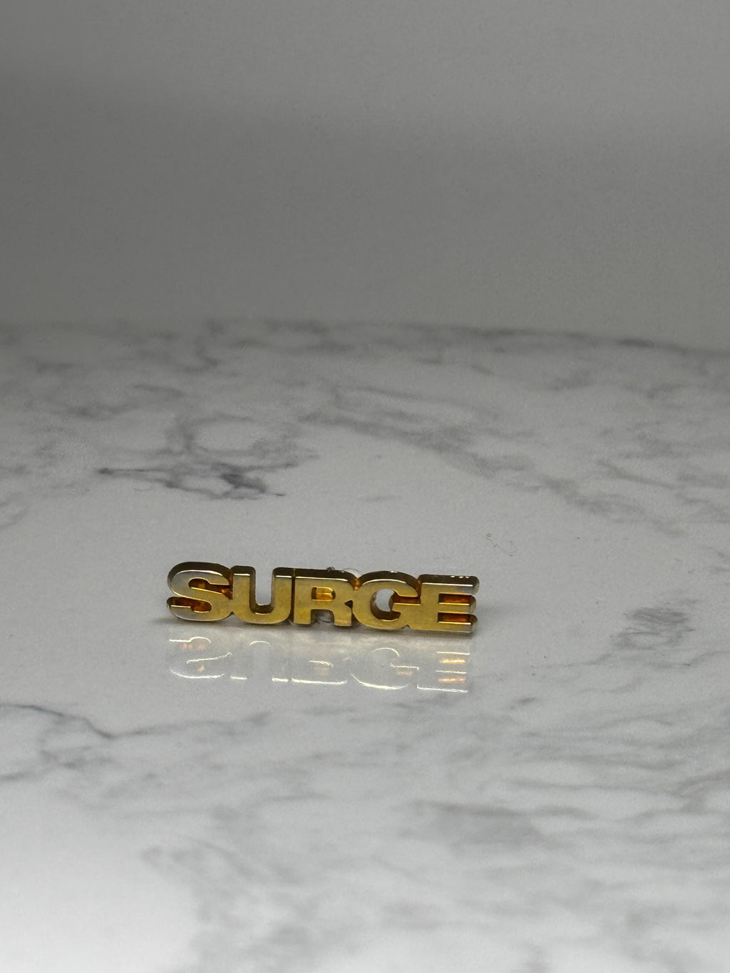 Surge Word Pin: Gold Tone Lettering - 1980s Motivational Accessory