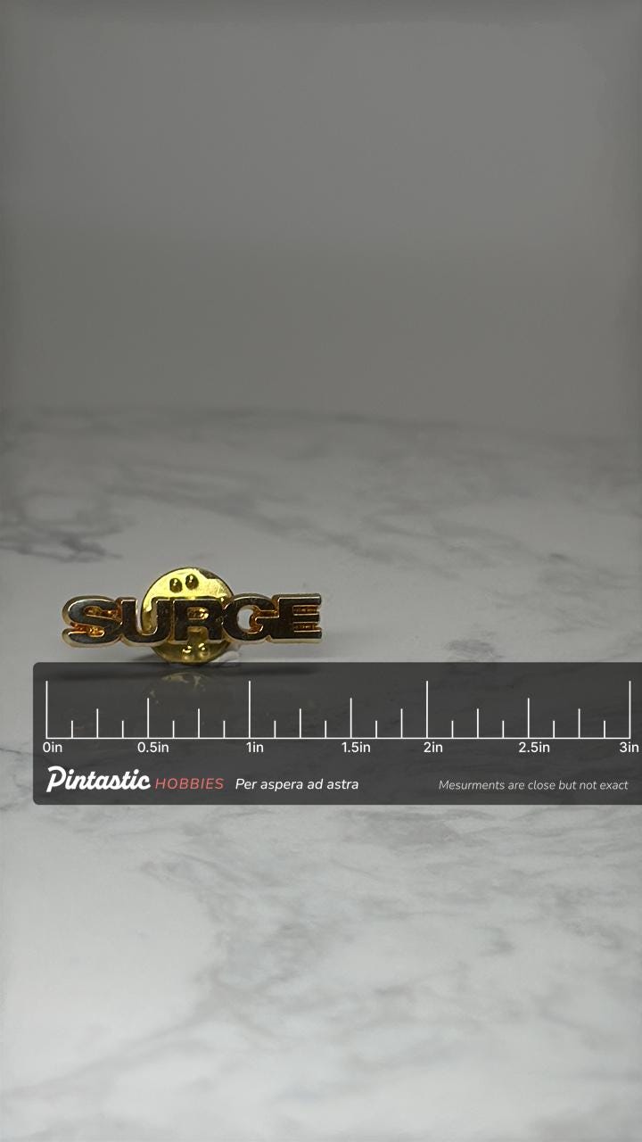 Surge Word Pin: Gold Tone Lettering - 1980s Motivational Accessory with ruler overlay for size reference