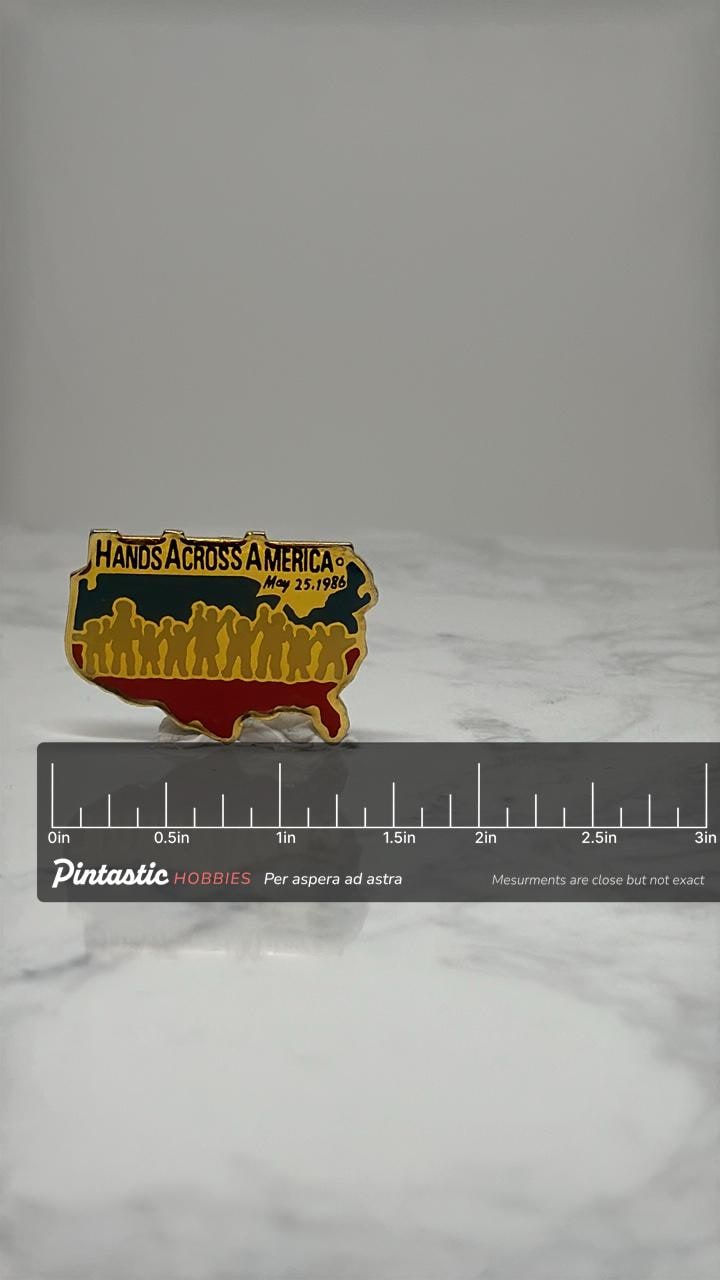 Hands Across America Pin: Gold Enamel - 1986 Charity Event with ruler overlay for size reference