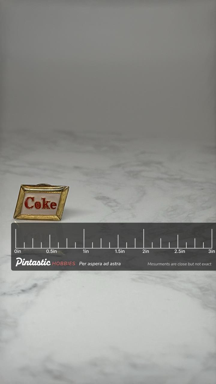 Coca Cola Logo Lapel Pin: Gold Tone Enamel - Vintage Soda Advertising Accessory with ruler overlay for size reference