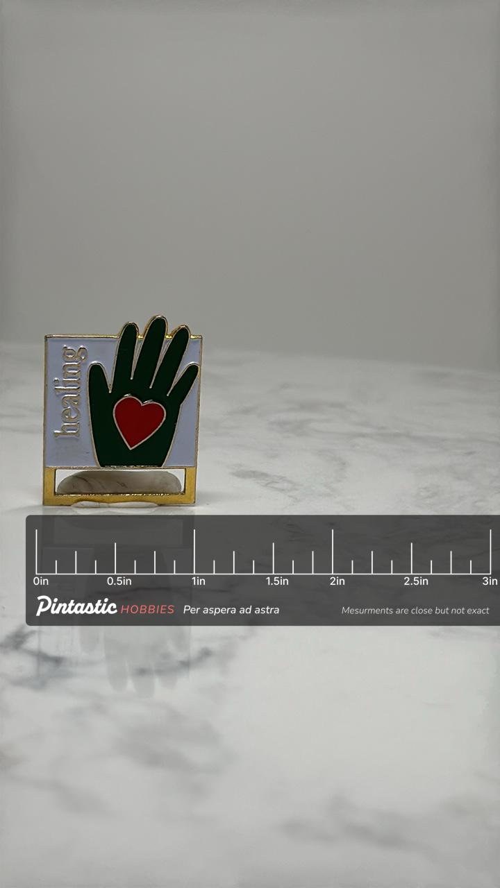 Healing Hand Enamel Pin: Green & Red Gold Tone - Charity Accessory with ruler overlay for size reference