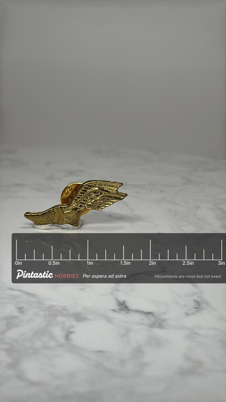 Vintage Winged Running Shoe Pin Track and Field Athletic Lapel Pin with ruler overlay for size reference