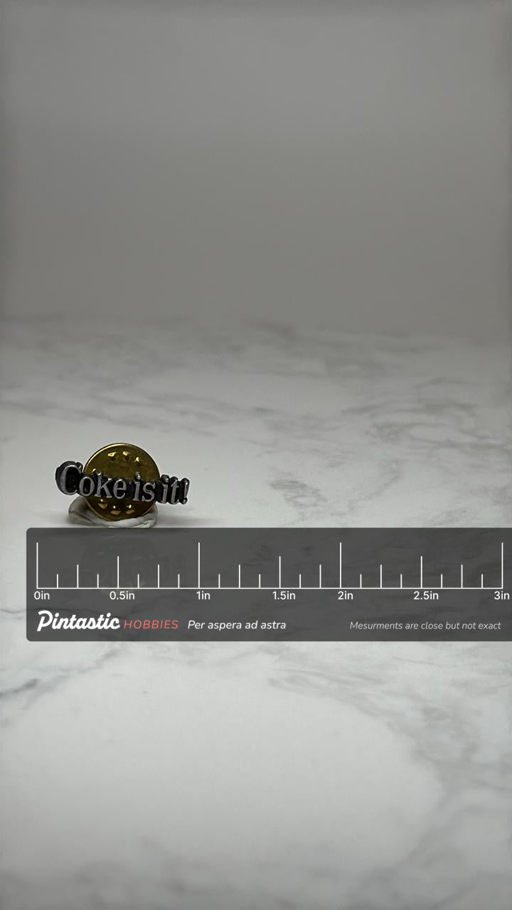 Coke is it! Slogan Pin: Black Enamel - 1980s Advertising Accessory with ruler overlay for size reference