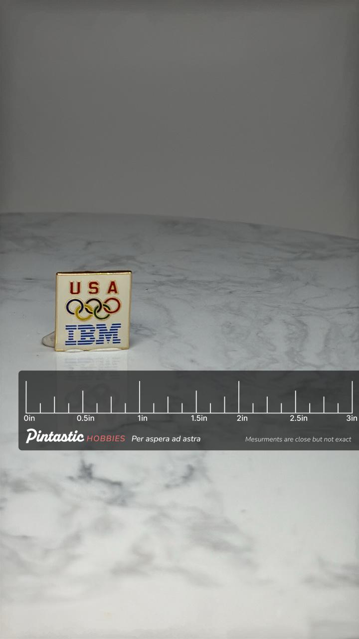 USA Olympic IBM Lapel Pin: Enamel Gold Tone - Patriotic Sports Accessory with ruler overlay for size reference