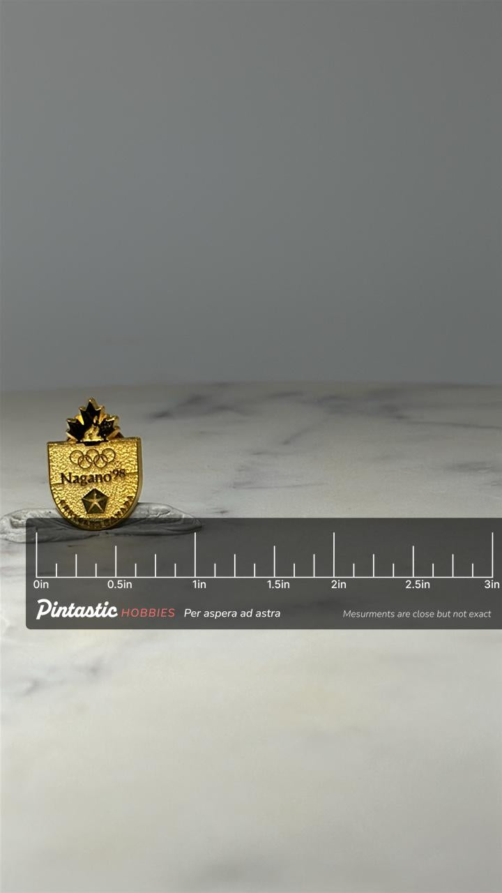 Nagano 1998 Olympics Pin: Gold Tone Shield - Winter Games Accessory with ruler overlay for size reference