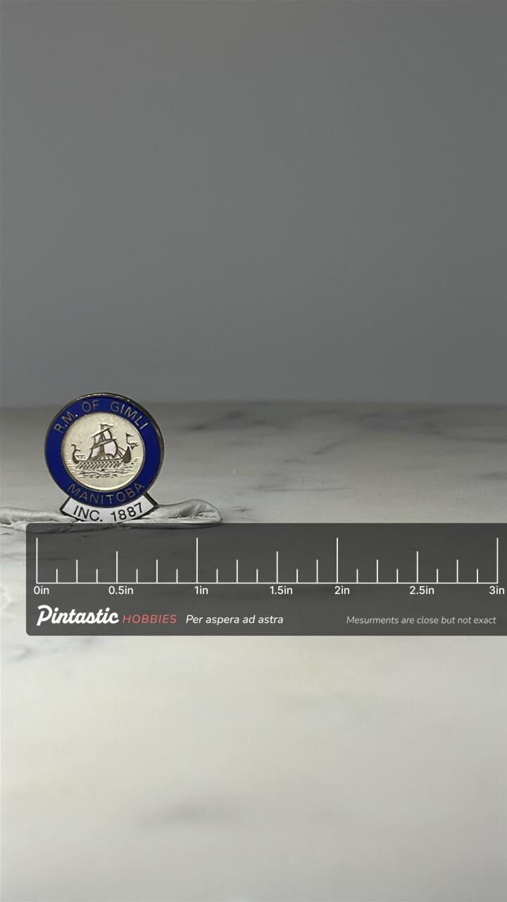 R.M. of Gimli Manitoba Pin: Blue Enamel - Canadian City Accessory with ruler overlay for size reference