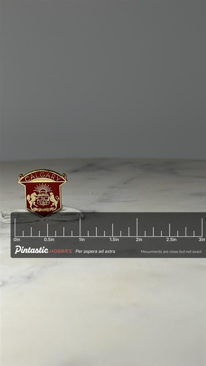Calgary Crest Enamel Pin: Red & Gold Shield - Canada Souvenir with ruler overlay for size reference