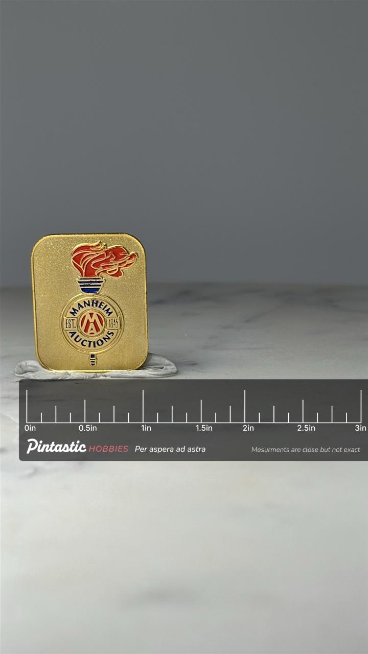 Manheim Auctions Enamel Pin: Gold Tone Torch - Est 1945 with ruler overlay for size reference