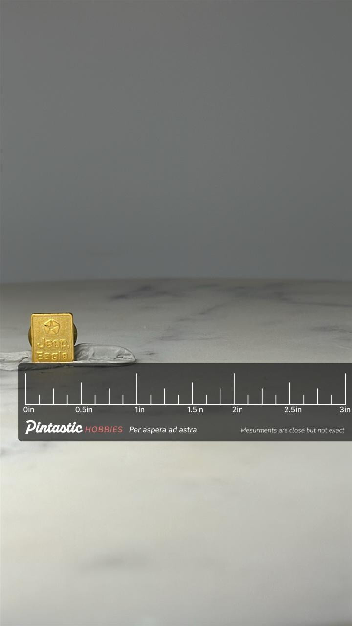 Jeep Eagle Logo Pin: Gold Tone - 1980s Auto Accessory with ruler overlay for size reference