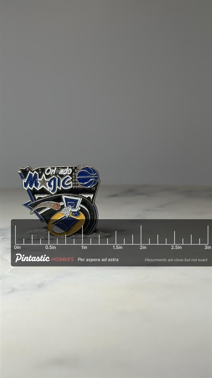 Orlando Magic Basketball Pin: Blue Enamel Logo - 1990s NBA Accessory with ruler overlay for size reference