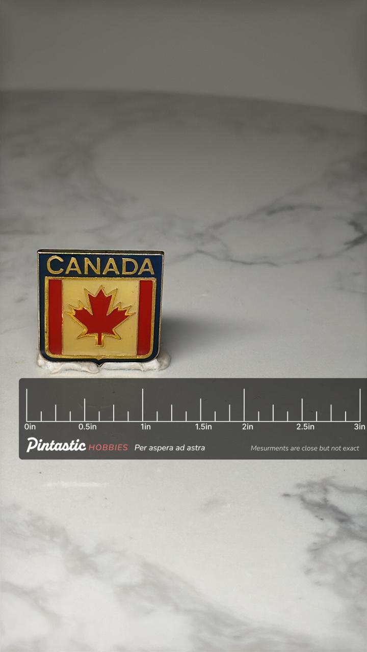 Canada Flag Enamel Pin: Red Yellow Blue Shield - Patriotic Accessory with ruler overlay for size reference