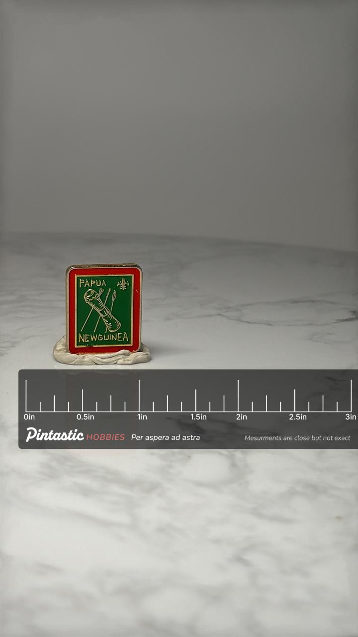 Papua New Guinea Souvenir Pin: Red & Green Enamel - Travel Accessory with ruler overlay for size reference
