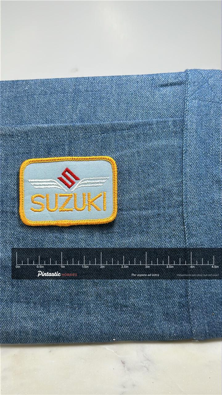 Suzuki Collectable Patch: Yellow Border Logo - Moto Accessory with ruler overlay for size reference