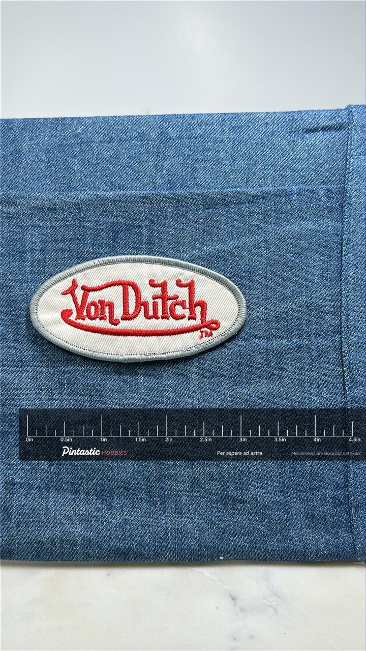 Von Dutch Collectable Patch: Red Script Oval - Y2K Fashion Accessory with ruler overlay for size reference