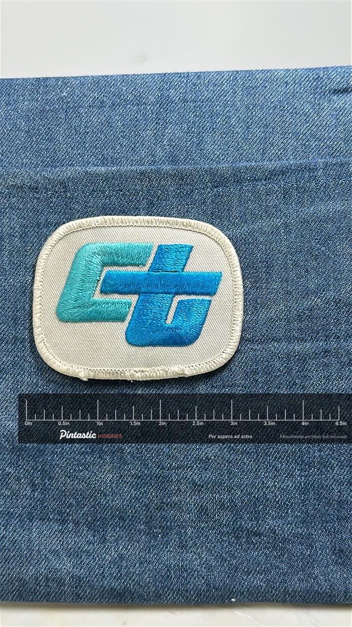 Caltrans CT Logo Patch: Teal Blue on White - 1970s Transport Accessory with ruler overlay for size reference